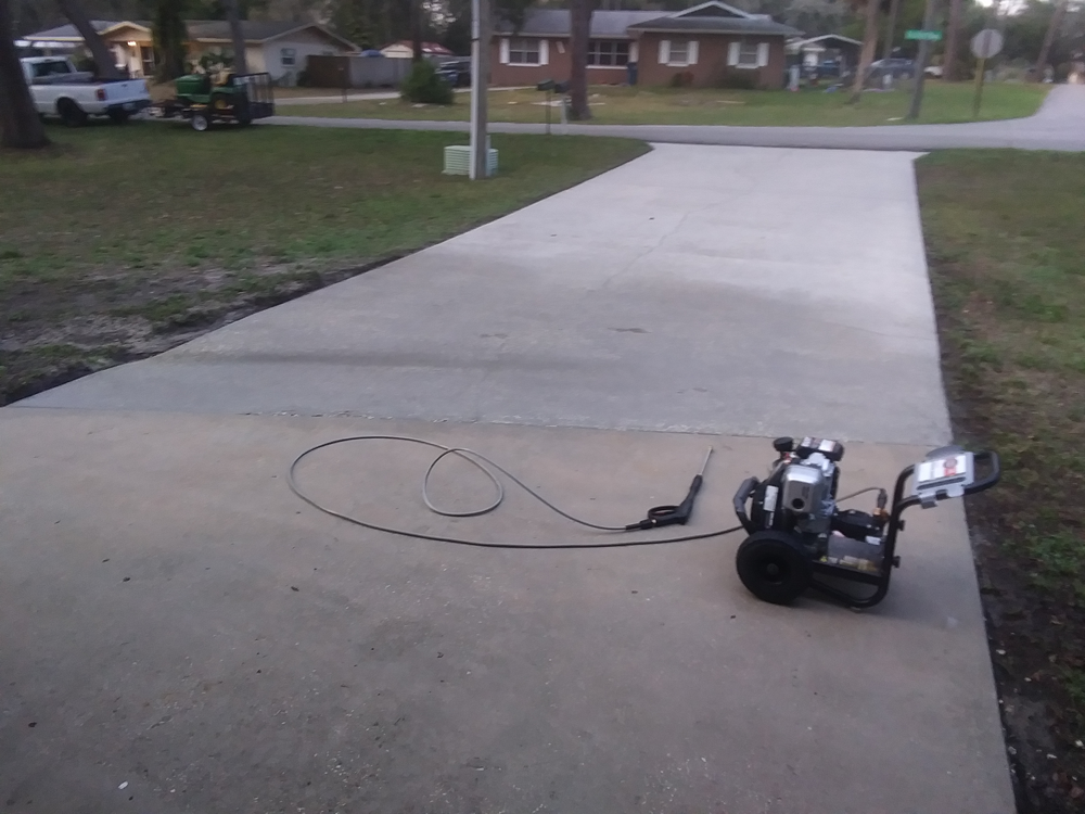 Pressure Washing - a driveway with Pressure Washing machine